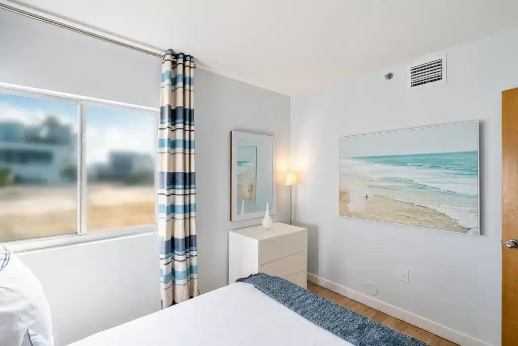 Modern bedroom with ocean view and queen bed at Art Basel Miami Beach vacation rental