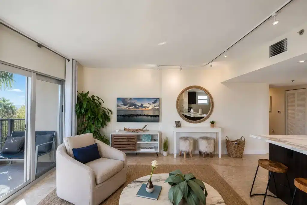 Modern Miami vacation home rental living room with waterfront view and coastal luxury decor
