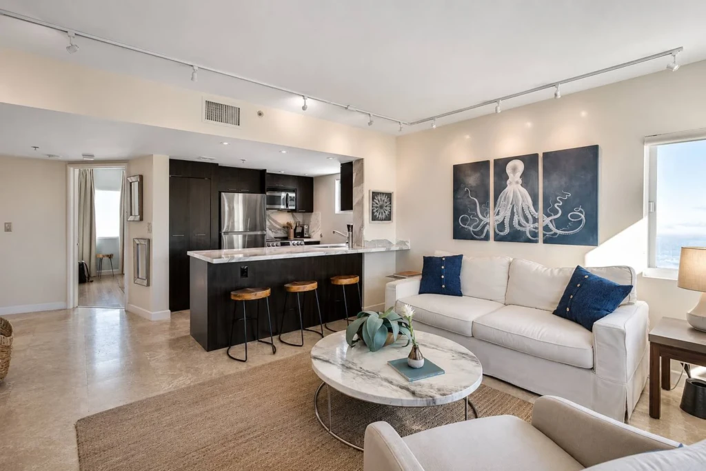 Modern open-concept living area with black kitchen and ocean view in Miami vacation home rental