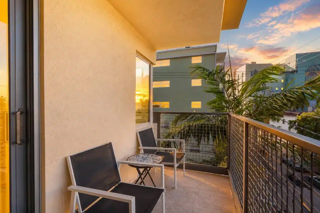 Modern balcony with sunset views at Miami Beach vacation home rental with contemporary seating
