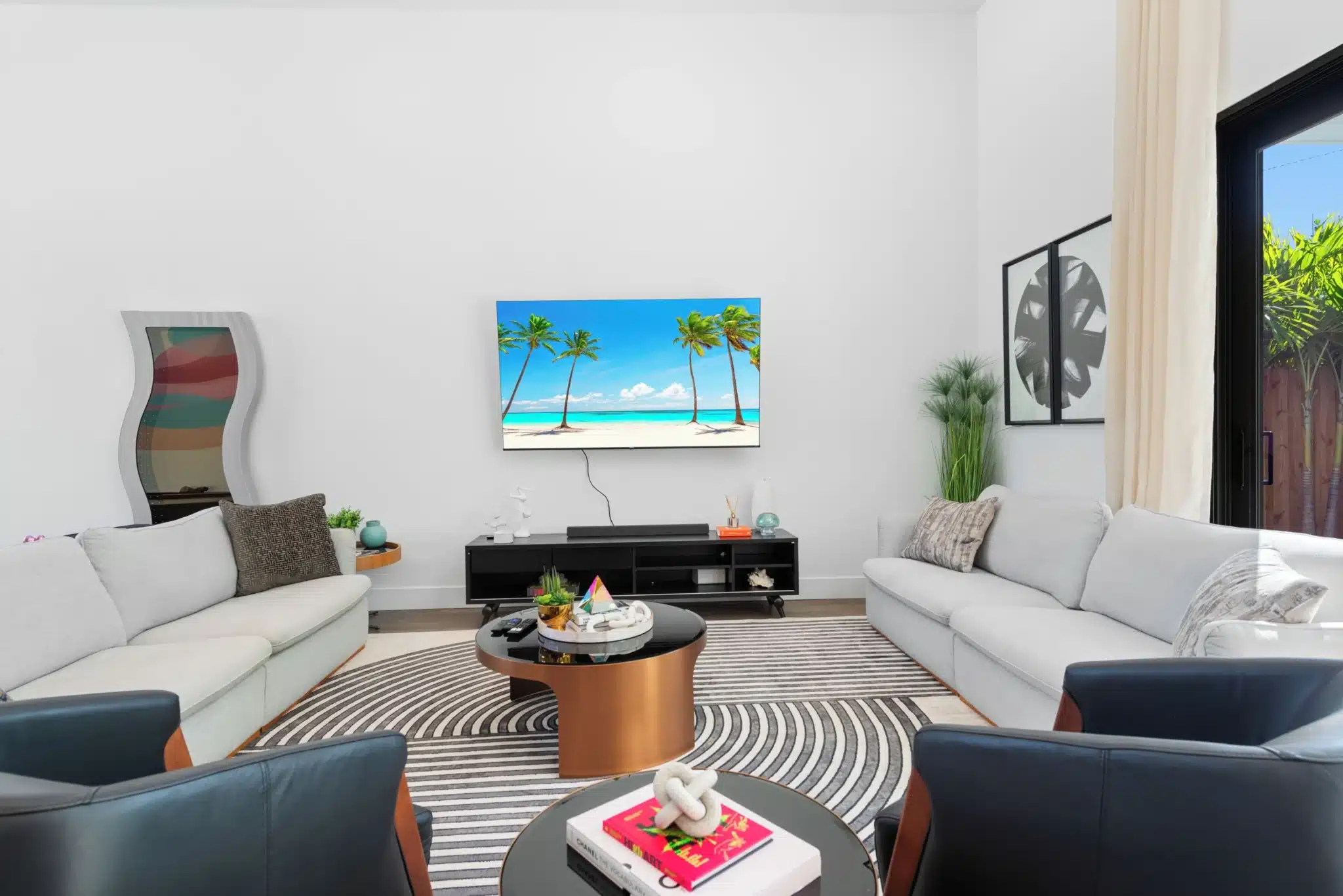 Modern living room with luxury sofas and beach view decor at Miami Beach compound