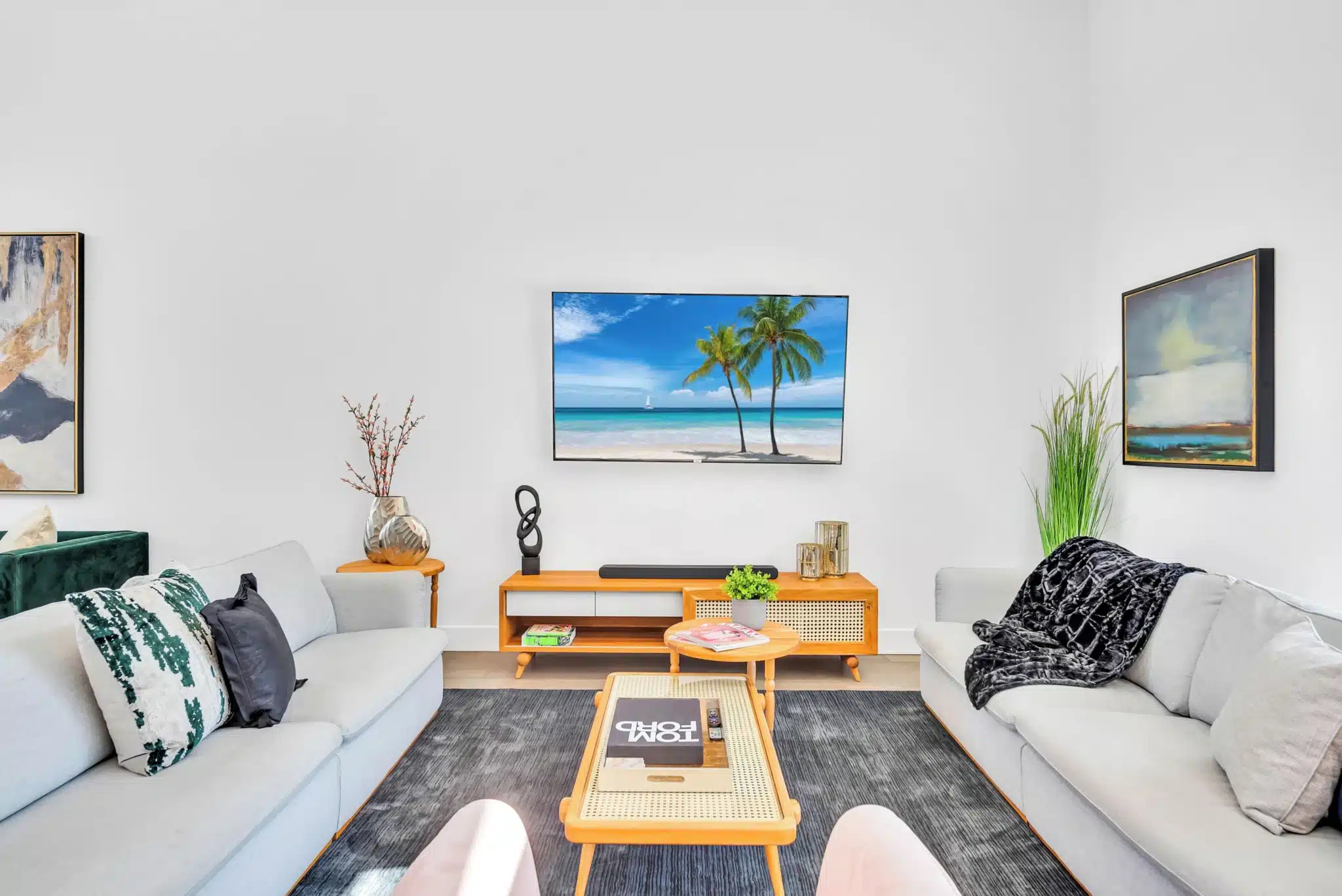 Modern living room with tropical art and designer furniture at a Miami Beach rental