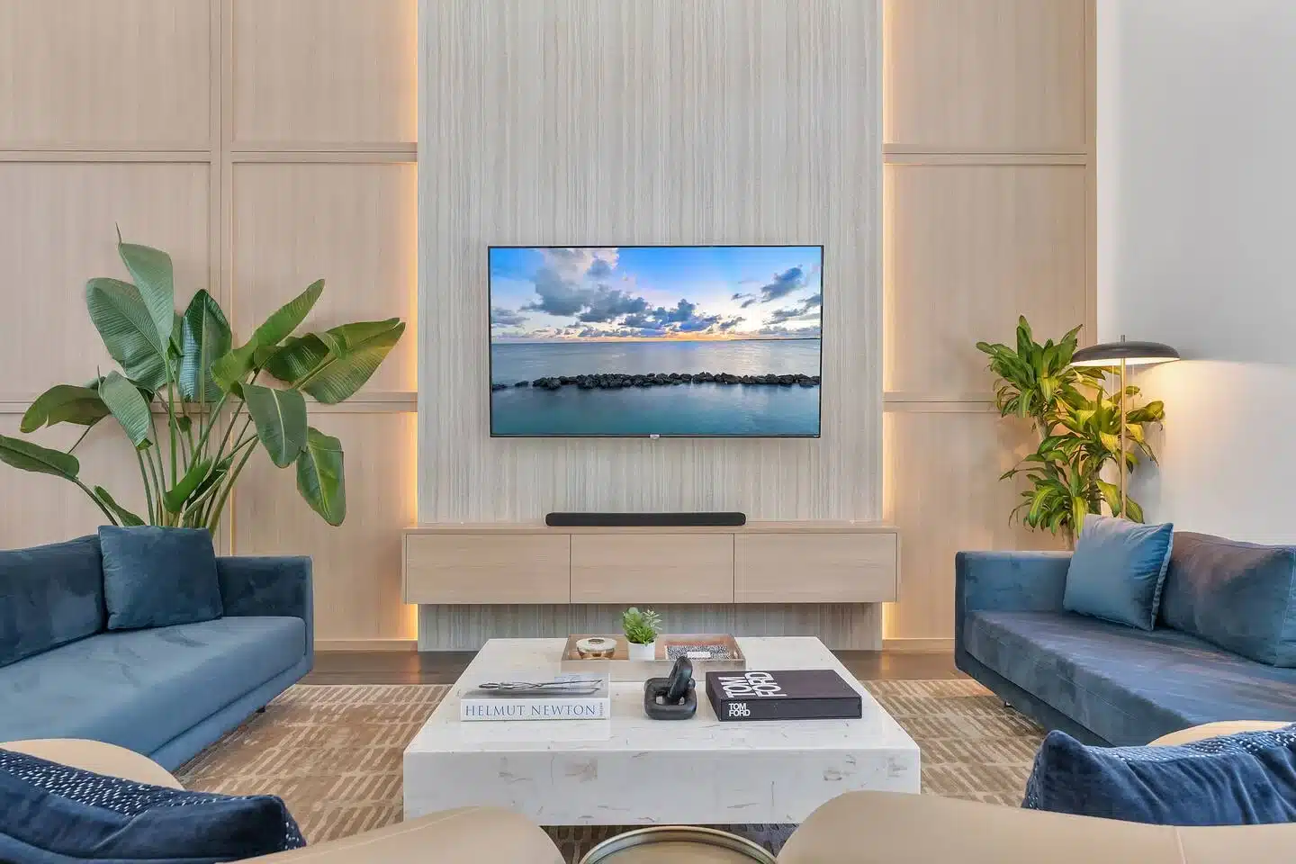 Modern Miami South Beach living room with ocean view on mounted TV and contemporary coastal design