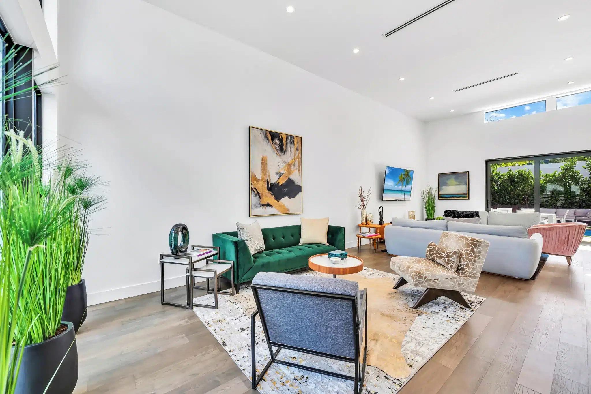 Contemporary living room with green velvet sofa and designer furniture in Wynwood Design District Miami rental