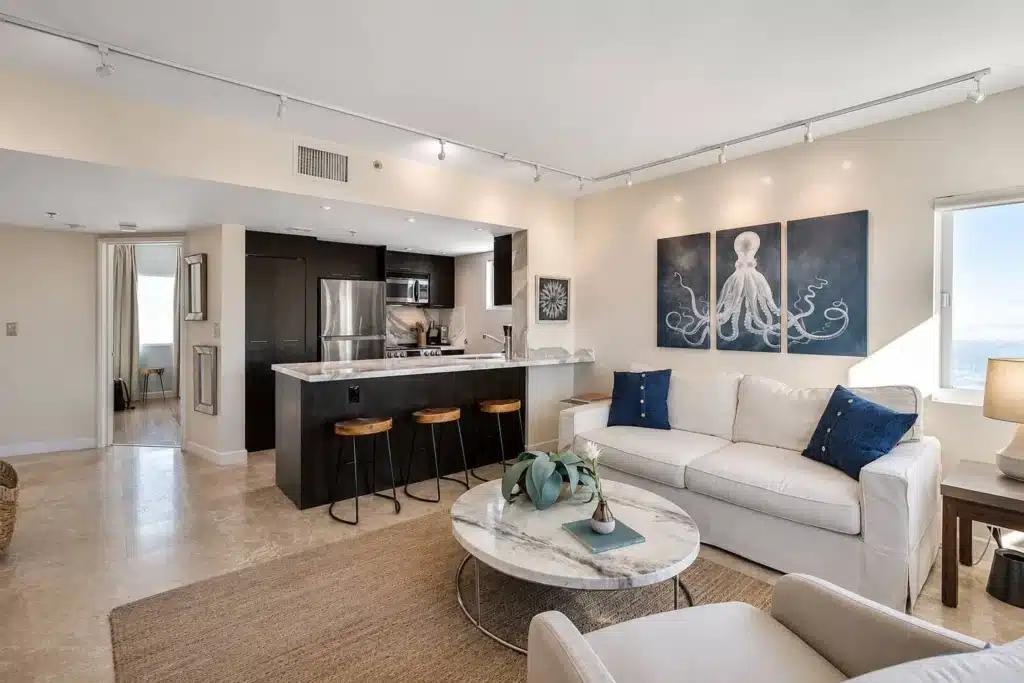Modern vacation rental living area with black kitchen and ocean views in Miami