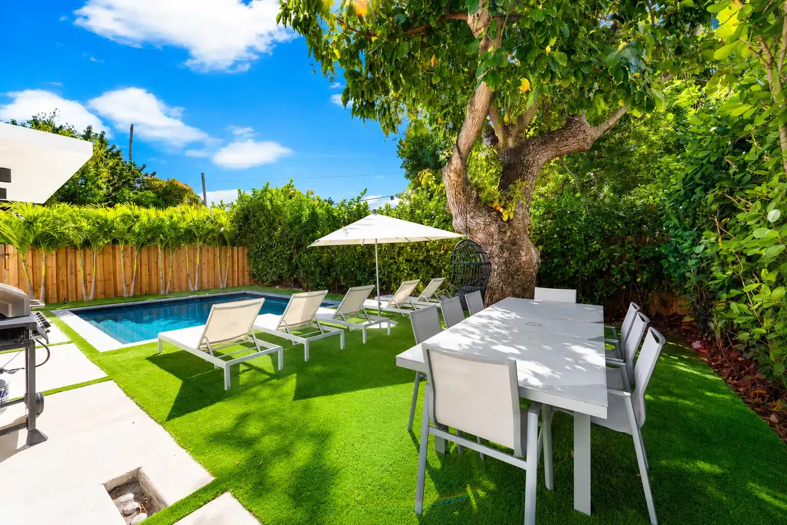 Private pool backyard with lounge chairs and a shade tree, a quiet Miami for couples escape