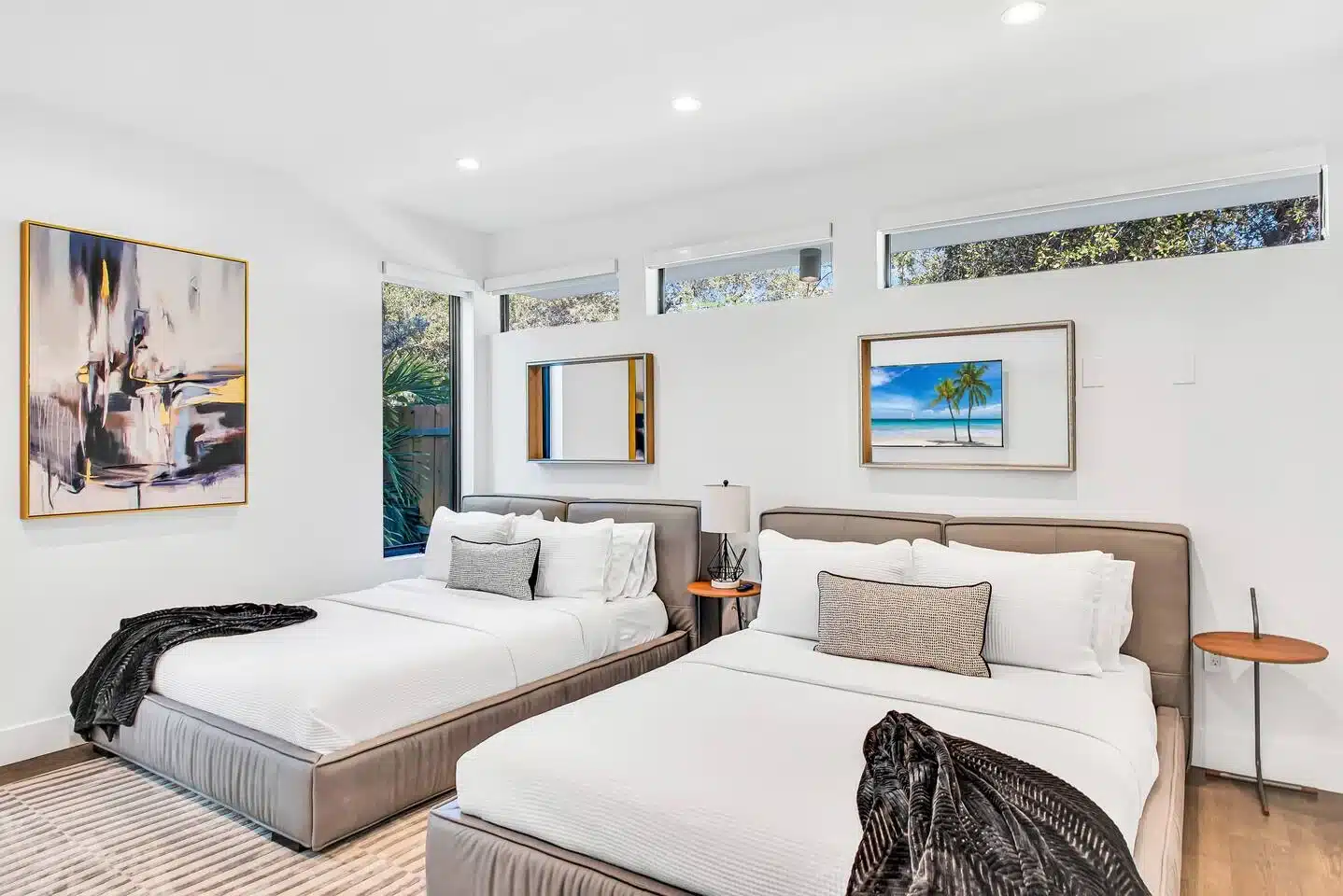 Luxury master bedroom with queen beds and modern decor at Miami Compound
