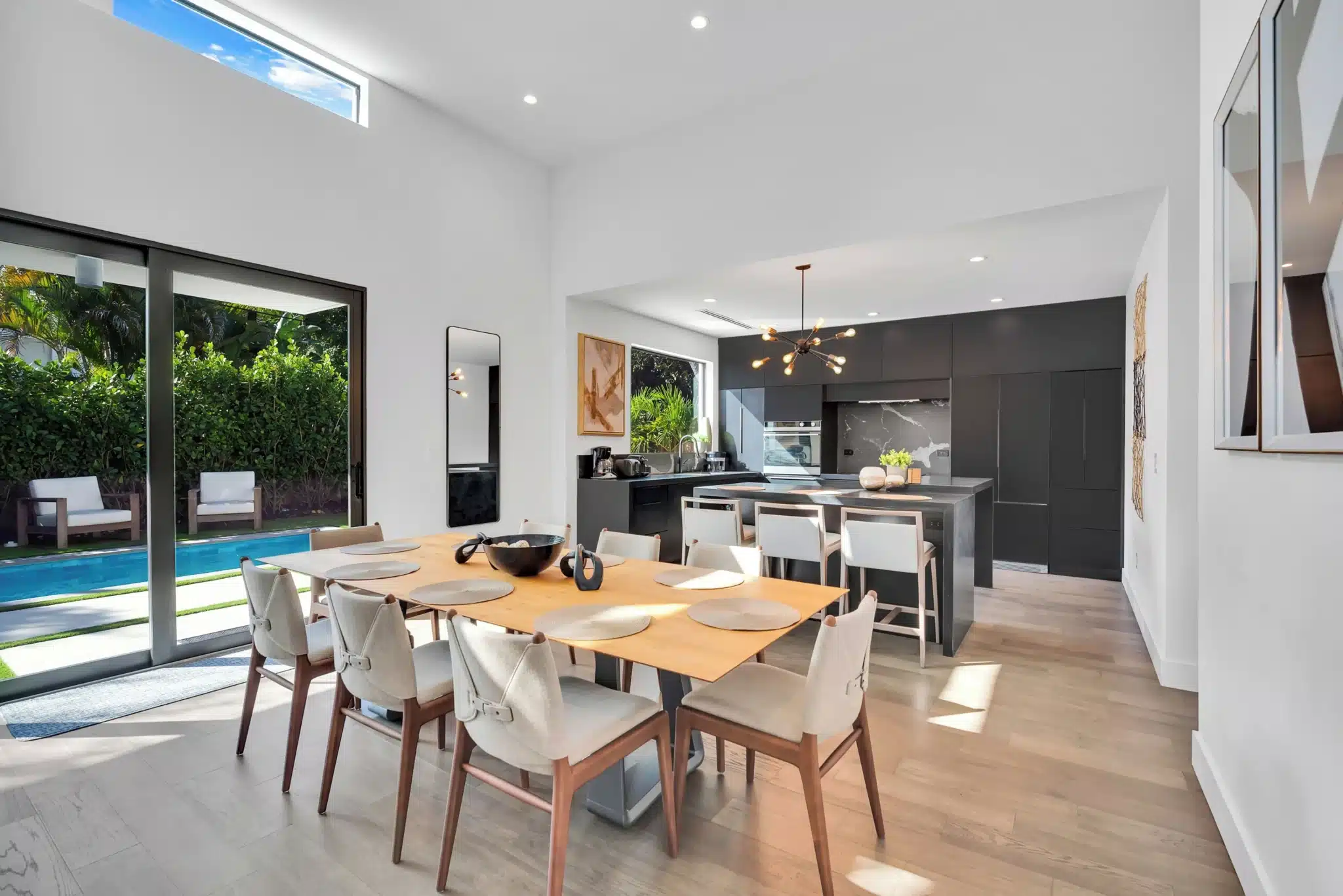 Modern dining area with pool view at Miami vacation rental for group dining entertainment