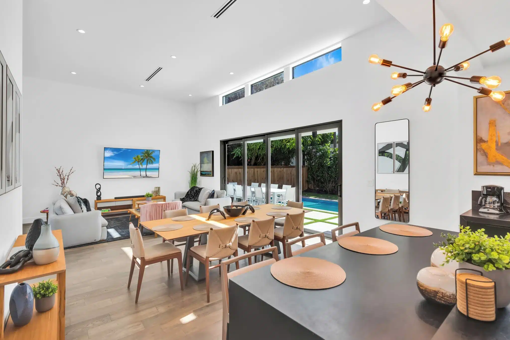 Modern open-concept living space with dining table and pool view in Miami Beach condo